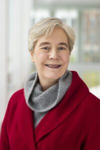 Dr. Ellen Williams smiles in a red blazer