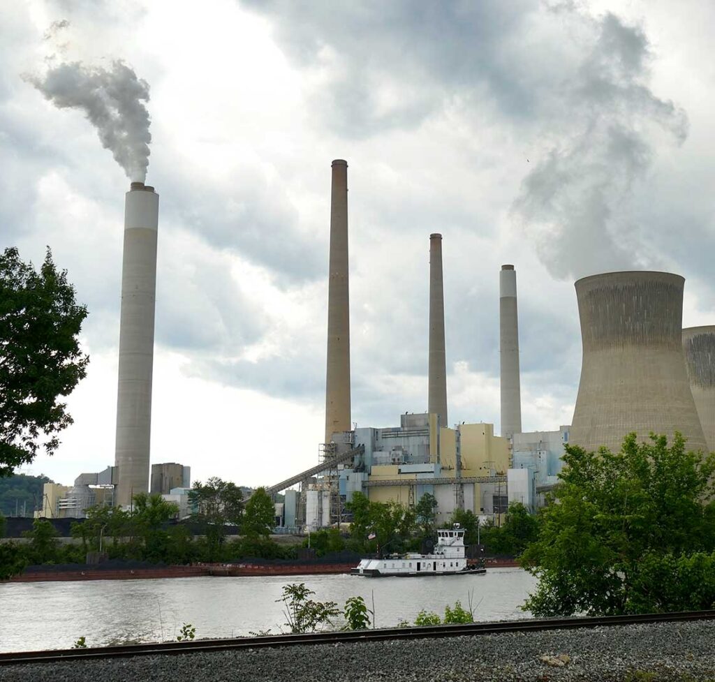The concrete plumes of a power plant emit steam into the atmosphere