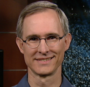 The headshot of Dr. Scott Braun, smiling at the camera wearing glasses and a blue polo