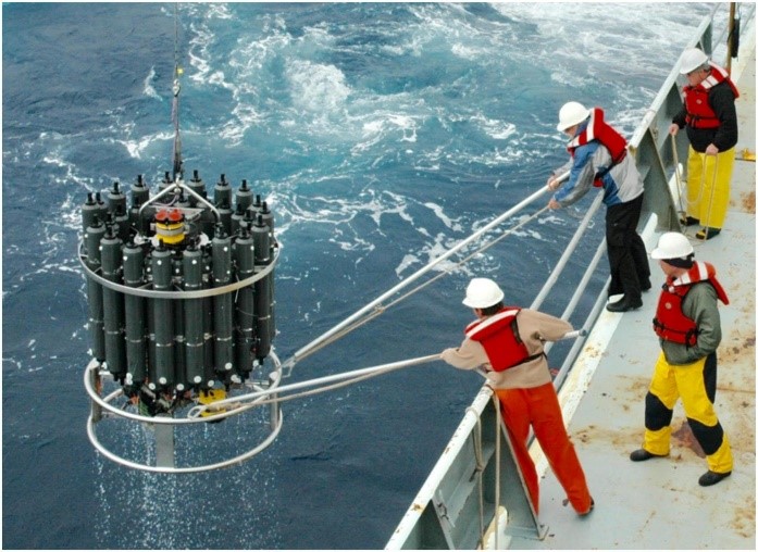 Figure: A rosette of Niskin (seawater sampling) bottles used to collect discrete water samples at specific, predetermined depths. Instruments for measuring depth, temperature, and conductivity (which helps determine salinity) are inside of the ring near the bottom (not visible). (Photo provided to Jiang et al. by Sabine Mecking of the University of Washington for the publication).